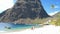 Huge pitons drone view at Saint Lucia sugar beach St Lucia mountains, couple men and woman waling at the white sugar