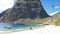 Huge pitons drone view at Saint Lucia sugar beach St Lucia mountains, couple men and woman waling at the white sugar