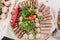 Huge plate serving appetizing meat snack and vegetable ready for eating top view