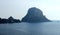 A huge pyramidal rock called Es VedrÃ¡ near the island of Ibiza