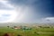 Huge rain storm over landscape in African village