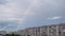 Huge Rainbow in the Cloudy Sky Above the Houses in City, Timelapse