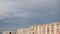 Huge Rainbow in the Cloudy Sky Above the Houses in City, Timelapse