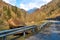 A huge rock fell from the mountains onto the road, destroying the asphalt and blocking half of the roadway