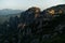 Huge rocks with christian orthodox monasteries at sunrise with Meteora valley in background near Kalambaka, Thessaly