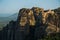 Huge rocks with christian orthodox monasteries at sunrise with Meteora valley in background near Kalambaka, Thessaly