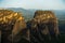 Huge rocks at christian orthodox sunrise with Meteora valley in background near Kalambaka, Thessaly