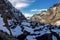 Huge rocks in Glope Valley near Byrkjedal and alpine landscape with frozen Indra Vinjavatnet lake in winter season