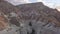 Huge rocky mountain covered in sand with a canyon at the foot of it, 4k