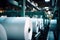 Huge rolls of paper are stored in the factory warehouse. Industrial paper production. Finished products of a paper processing