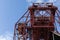 Huge rusting overhead industrial metal structure, caged ladders, blue sky