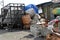 Huge sacks of recyclable materials being stacked and sorted by workers in the city junk yard shop