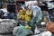 Huge sacks of recyclable materials being stacked and sorted by workers in the city junk yard shop