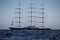 A huge sail yacht of conceptual design with three masts stands in the bay near Monaco at sunny day, the sails are