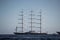 A huge sail yacht of conceptual design with three masts stands in the bay near Monaco at sunny day, the sails are