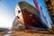 huge ship under construction, with workers welding and painting the exterior