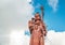 Huge Shiva statue Mangal Mahadev is a 33 m art piece in Ganga talao temple on the blue cloudy sky, Mauritius island