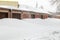 Huge snow banks near garage doors in winter during blizzard