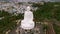 a huge statue of a seated Buddha on a hill