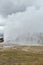 Huge steam clouds and mist above Old Faithful