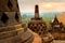 Huge stone Buddhist stupas against the background of the sunrise in the Borobudur Temple. Java island. Indonesia. Famous historic