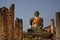 Huge stone statute of buddha looking forward wrapped in orange clock monastry Phonsavan, Laos