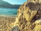 Huge stones lie on the beach near the sea. sand boulder, rock. a stone lies on the seashore and is washed by water against the