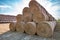 Huge straw pile of Hay roll bales on among harvested field. cattle bedding