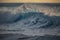 Huge surfing waves against ocean water background