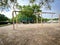 Huge swings with colorful plastic eggs on mulch ground for kids Easter egg hunt activity at large playground with oak trees near