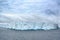 Huge table iceberg in front. Turquoise and white iceberg in Antarctica.