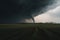 Huge tornado swirling over field, created using generative ai technology