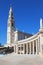 A huge tower, topped by a cross and a colonnade