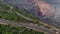 A huge truck is driving on a road near the massive quarry, 4k