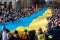Huge Ukrainian flag along in Vilnius, carried by people with Lithuanian and Ukrainian flags
