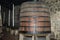 Huge vertical barrels of port. Dimensional levels are set along the barrels. The barrels are standing on stone pedestals