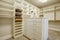 Huge walk-in closet with shelves, drawers and shoe racks.