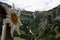 Huge waterfall meanders over several steps into the valley with a wooden edelweiss blossom