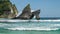 Huge wave hit the Rock stick out of the ocean at Atuh beach,.Foam is splashing over the Rock. Nusa Penida, Indonesia