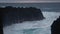 Huge waves of the atlantic ocean are breaking on black rocks