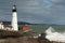 Huge Waves Break by Illuminated Portland Head Lighthouse in Main