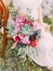 The huge wedding bouquet of colourful exotic flowers in the hands of the bride.