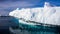 Huge white frozen iceberg float in open ocean