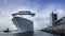 Huge white luxury cruise ship leaving port