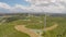 Huge wind turbines rotating under cloudy sky, sunny weather changing to rainy