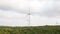 Huge windmills, wind turbines generating electricity on windy day