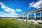 huge windows reflecting blue sky on a modern ranch