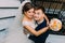 Hugging happy newlyweds standing near the stairs. The above portrait.