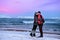 Hugging pair of teenagers on the coast of Barents Sea in Teriberka, Murmansk Region, Russia