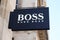Hugo Boss logo brand and text sign on entrance shop luxury store of German boutique